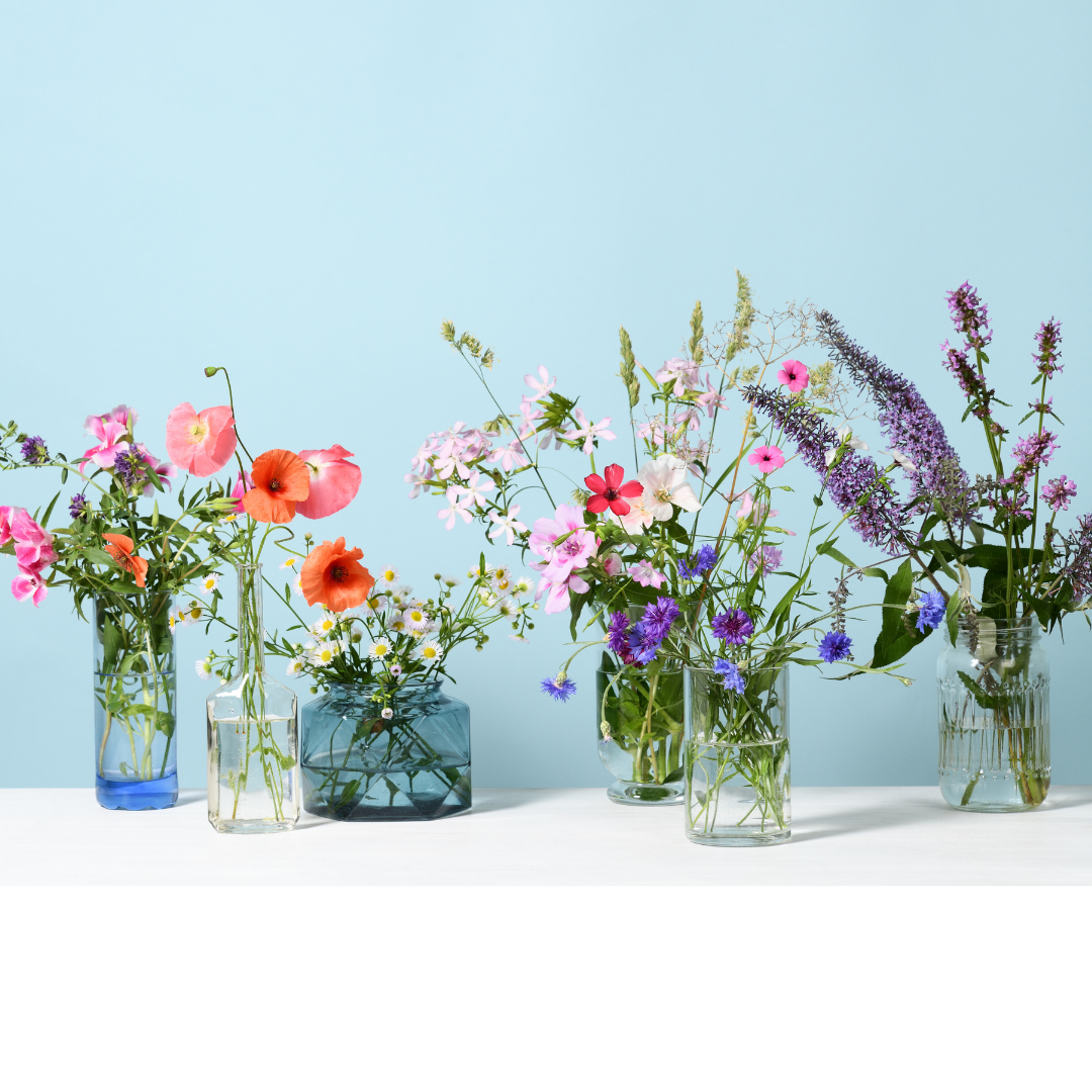 Flowers in Assorted Glass Bottles